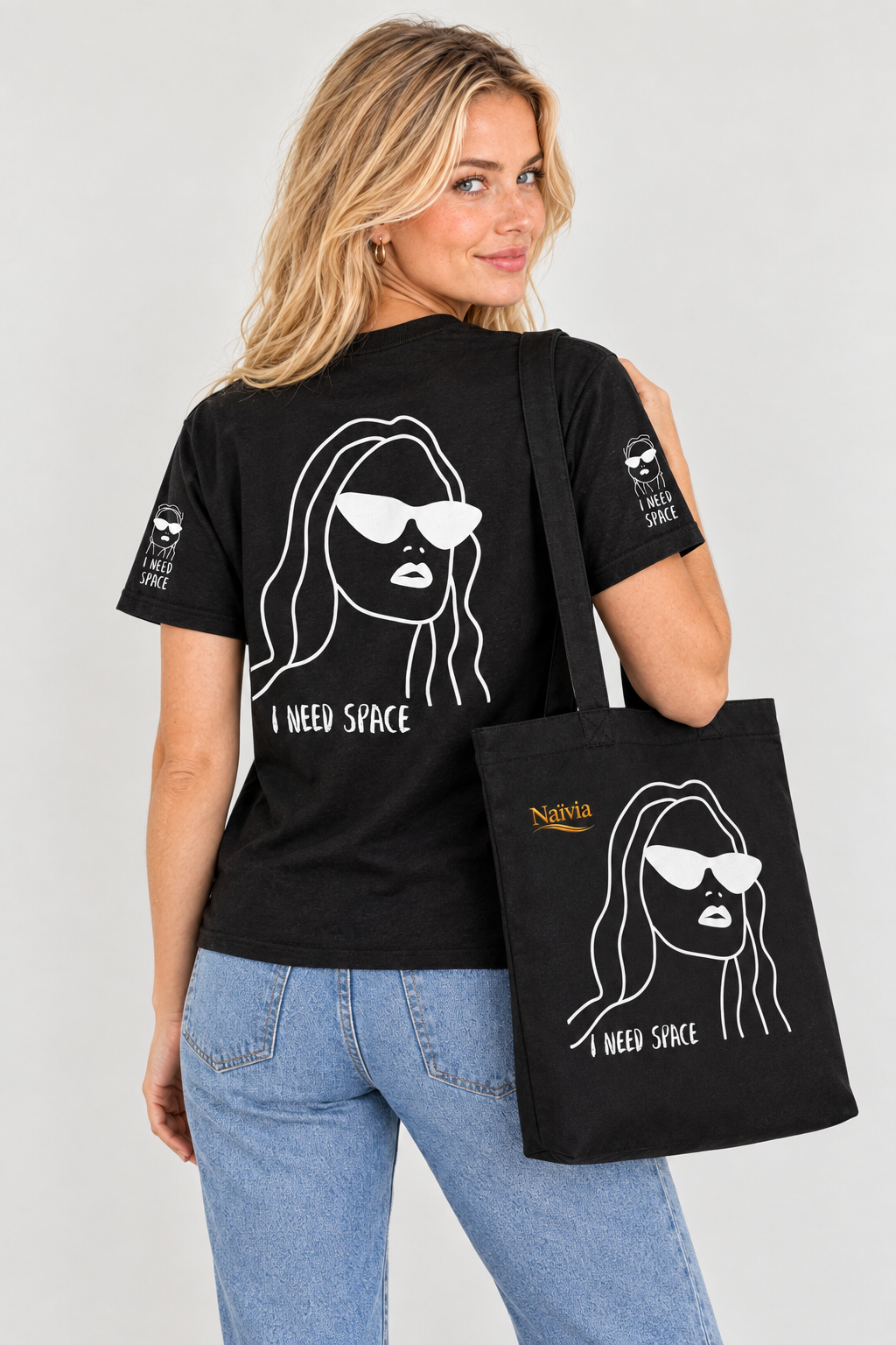 Back view of woman wearing the I Need Space T-shirt and carrying the matching tote